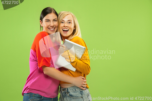 Image of Portrait of pretty girls isolated on green studio background