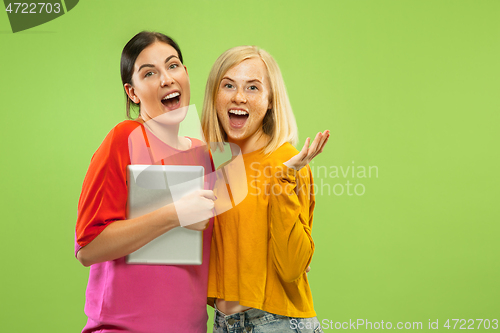 Image of Portrait of pretty girls isolated on green studio background