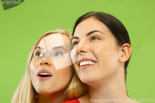 Image of Portrait of pretty girls isolated on green studio background