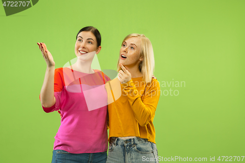 Image of Portrait of pretty girls isolated on green studio background