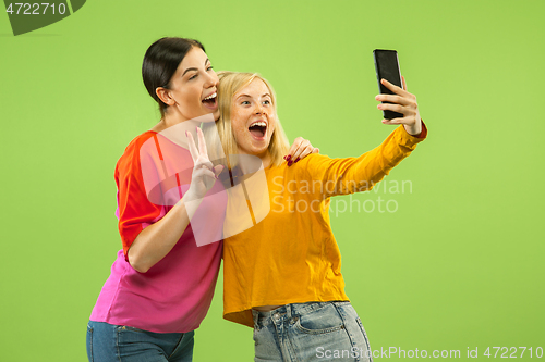 Image of Portrait of pretty girls isolated on green studio background