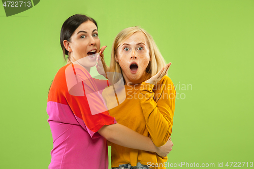 Image of Portrait of pretty girls isolated on green studio background