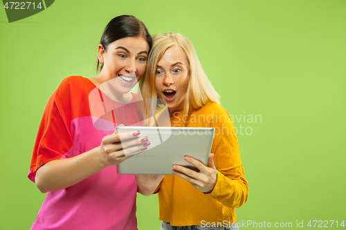 Image of Portrait of pretty girls isolated on green studio background