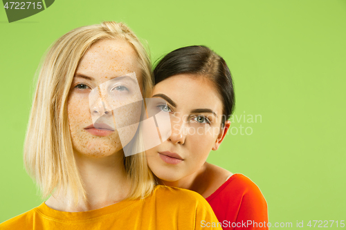 Image of Portrait of pretty girls isolated on green studio background