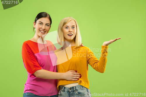 Image of Portrait of pretty girls isolated on green studio background