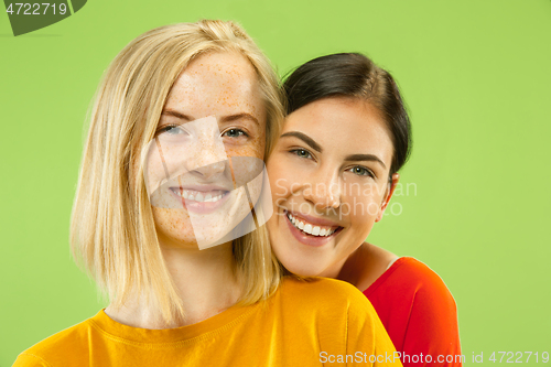 Image of Portrait of pretty girls isolated on green studio background