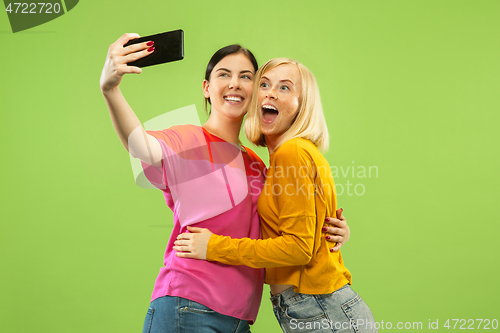 Image of Portrait of pretty girls isolated on green studio background