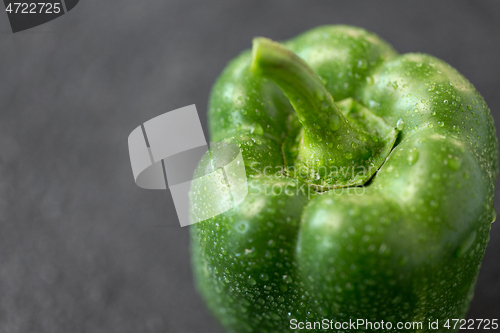 Image of close up of green pepper on slate stone background