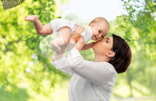 Image of happy mother kissing little baby daughter