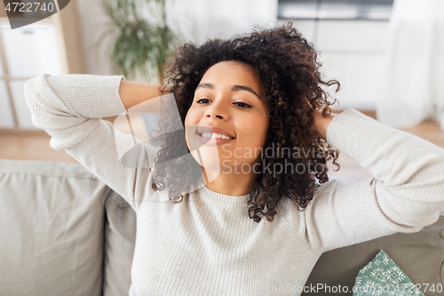 Image of happy african american young woman at home