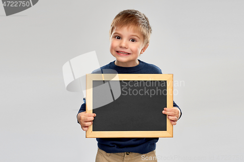 Image of little boy holding black blank chalk board