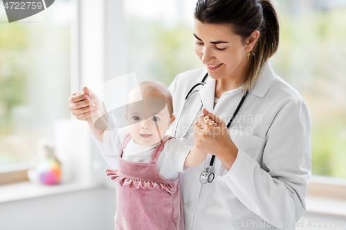 Image of female pediatrician doctor with baby at clinic