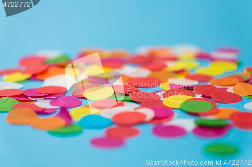 Image of colorful confetti decoration on blue background