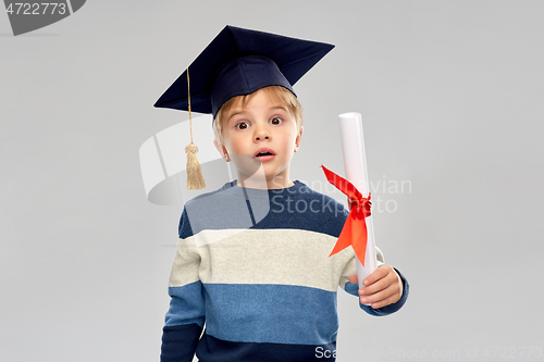 Image of little boy in mortarboard with diploma