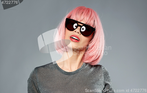 Image of happy woman in pink wig and black sunglasses