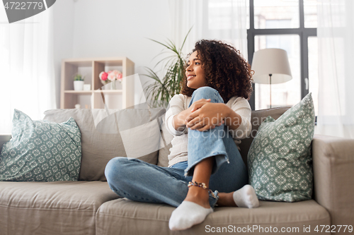 Image of happy african american young woman at home