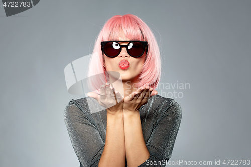 Image of woman in pink wig and sunglasses sending air kiss