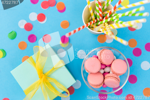 Image of birthday gift, macarons and paper straws for party