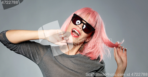 Image of happy woman in pink wig and black sunglasses