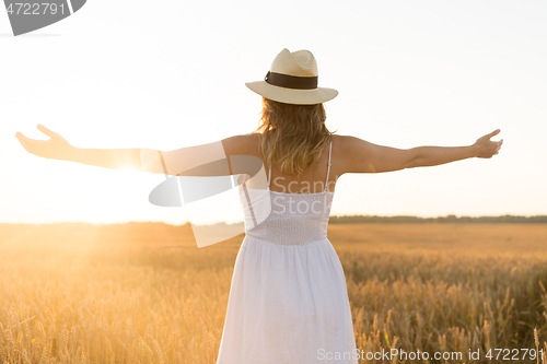 Image of happy woman in straw hat on cereal field in summer