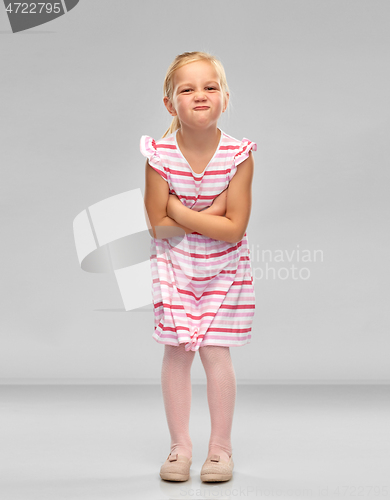 Image of displeased little girl with crossed arms pouting