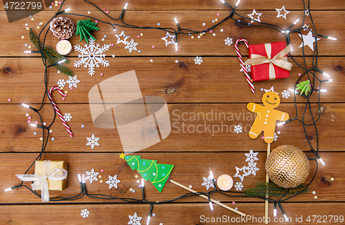 Image of christmas gifts and decorations on wooden boards