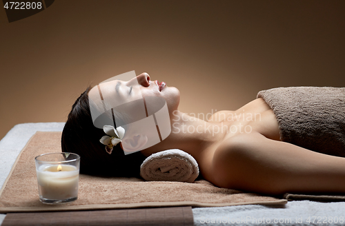 Image of young woman lying at spa or massage parlor