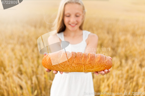 Image of girl with loaf of white bread on cereal field