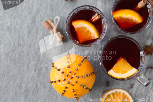 Image of hot mulled wine, orange slices, raisins and spices