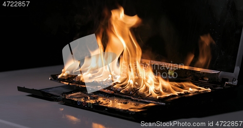 Image of Burning laptop computer electronics closeup