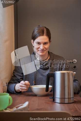 Image of Woman eating breakfast bowl of cereals