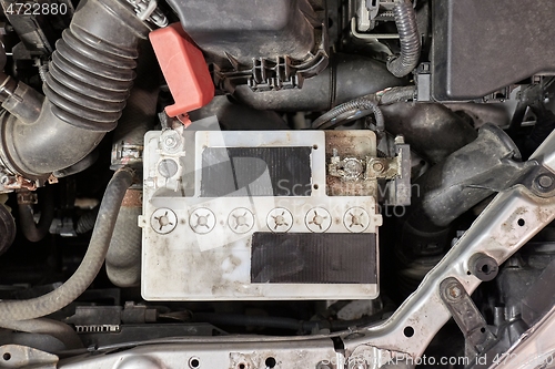 Image of Old starter battery in a car