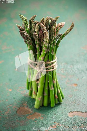 Image of Green asparagus on old kitchen table