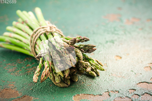 Image of Green asparagus on old kitchen table