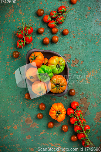 Image of Assortment of organic tomatoes on old kitchen table