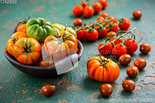 Image of Assortment of organic tomatoes on old kitchen table