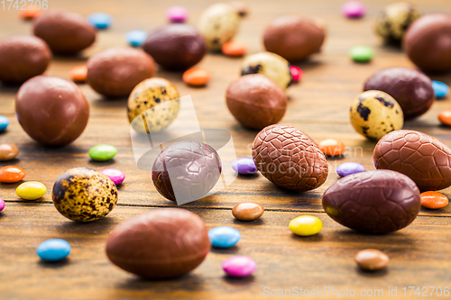 Image of Sweet chocolate eggs and colorful sweets for Easter