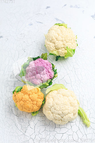 Image of Organic colorful cauliflower on old kitchen table