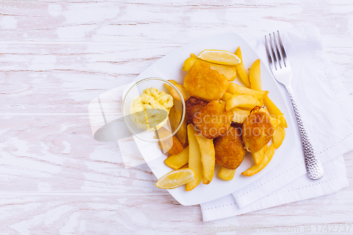 Image of Fish and chips with dip on white plate