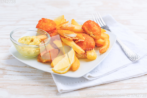 Image of Fish and chips with dip on white plate