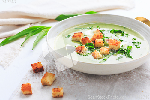 Image of Ramson or bear leek soup with crouton and sour cream