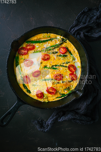 Image of Delicious fritatta with green asparagus and cherry tomatoes