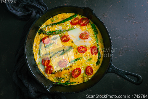 Image of Delicious fritatta with green asparagus and cherry tomatoes