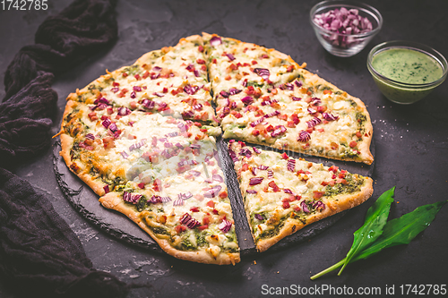 Image of Tart flambee (Flammkuchen) with ramson sour cream, onion and bacon