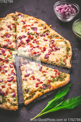 Image of Tart flambee (Flammkuchen) with ramson sour cream, onion and bacon