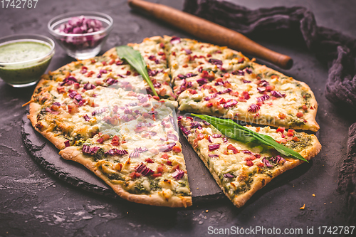 Image of Tart flambee (Flammkuchen) with ramson sour cream, onion and bacon