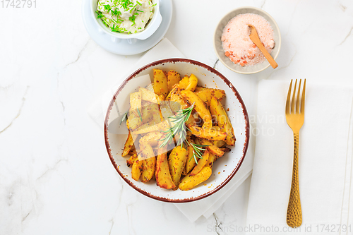 Image of Homemade baked potato wedges with garlic dip