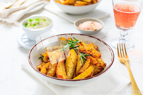 Image of Homemade baked potato wedges with garlic dip