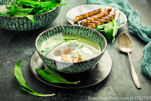 Image of Bear leek soup or ramson soup with crouton, sour cream and turkey skewer