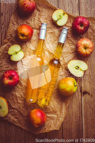 Image of Apple juice with apple vinegar in bottles and fresh apples